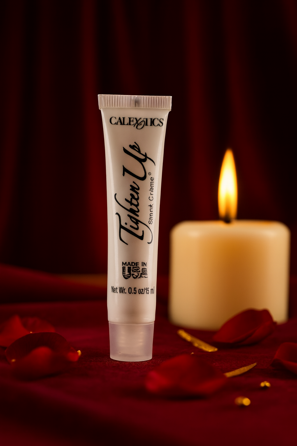 RoyalLuxsLLC vaginal tightening cream tube on red fabric with rose petals and lit candle