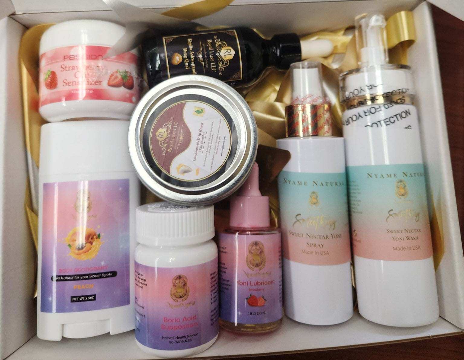 RoyalLuxsLLC herbal intimacy box featuring assorted body care products including lotions, lubricants, and sprays in a gift set