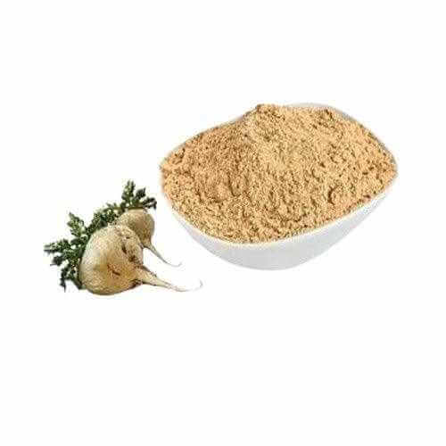 White bowl filled with organic maca powder next to fresh maca roots on white background