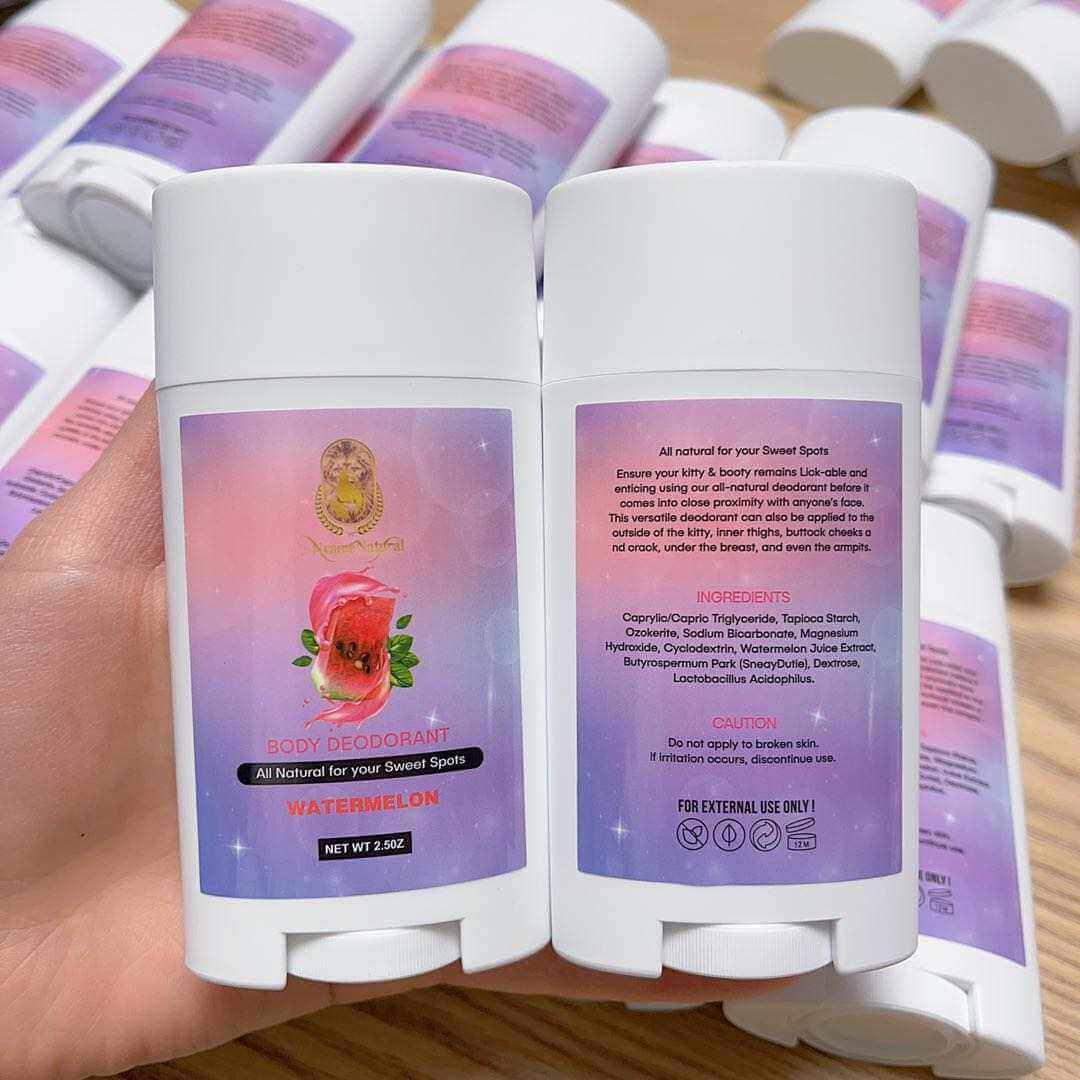 Booty deodorant sticks in hand with watermelon scent, showcasing natural ingredients and vibrant packaging.